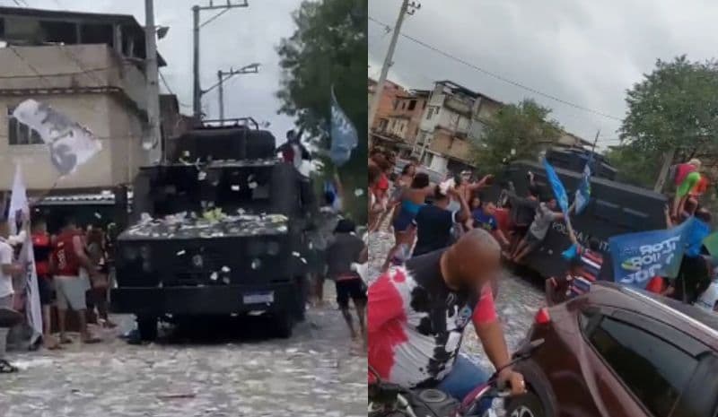 Moradores sobem em carro blindado da PM e jogam santinho