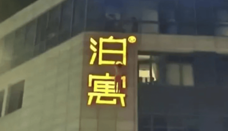 Homem tenta escapar da esposa e fica pendurado em prédio de cueca