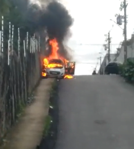 Nesta segunda-feira, 13, um carro em chamas, de modelo não identificado, desceu uma ladeira no bairro Vila da Prata e atingiu uma casa.