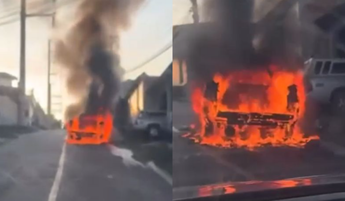 Carro pega fogo no meio da rua no bairro Petrópolis